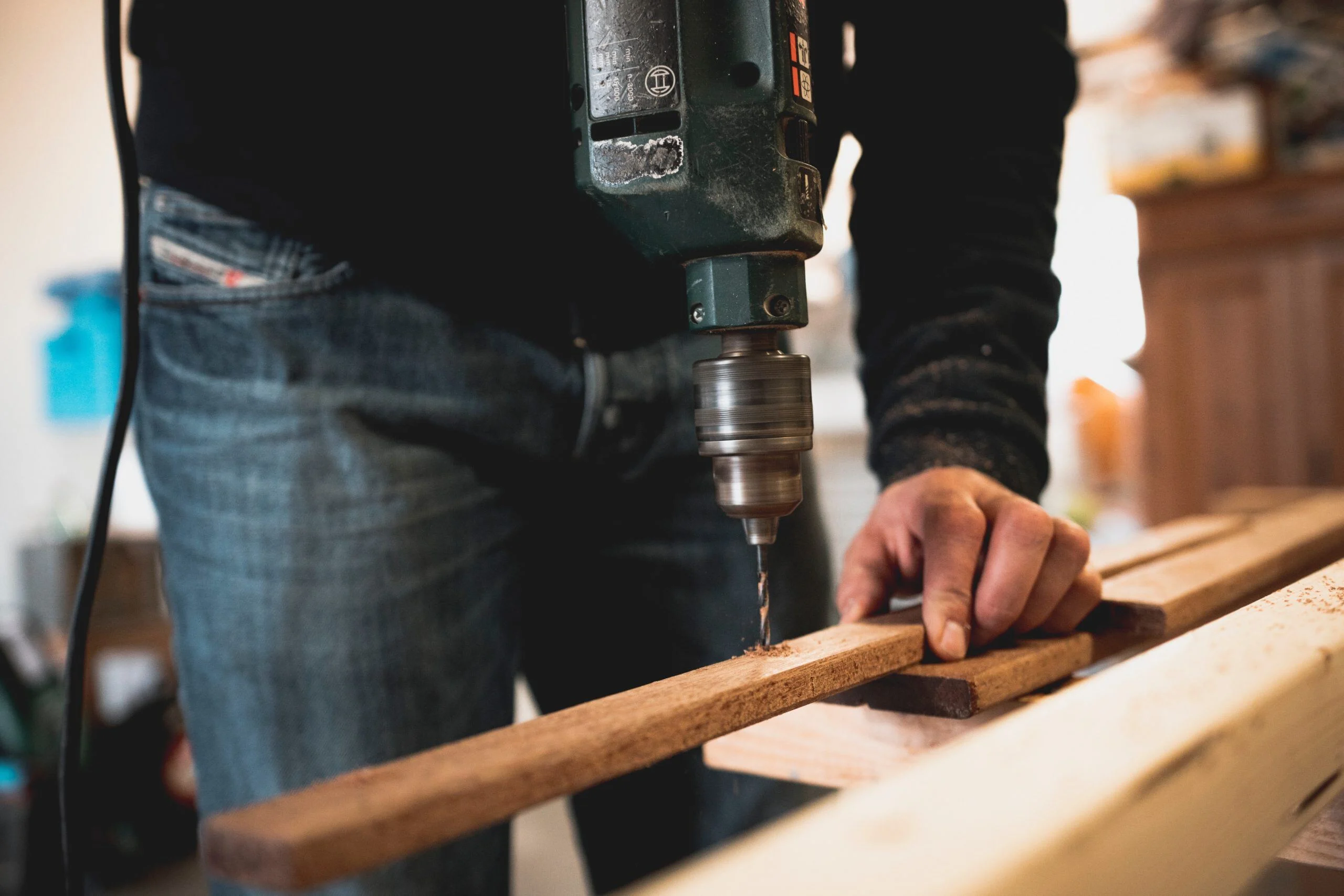 man-holding-wooden-stick-while-drilling-hole-1094767-scaled