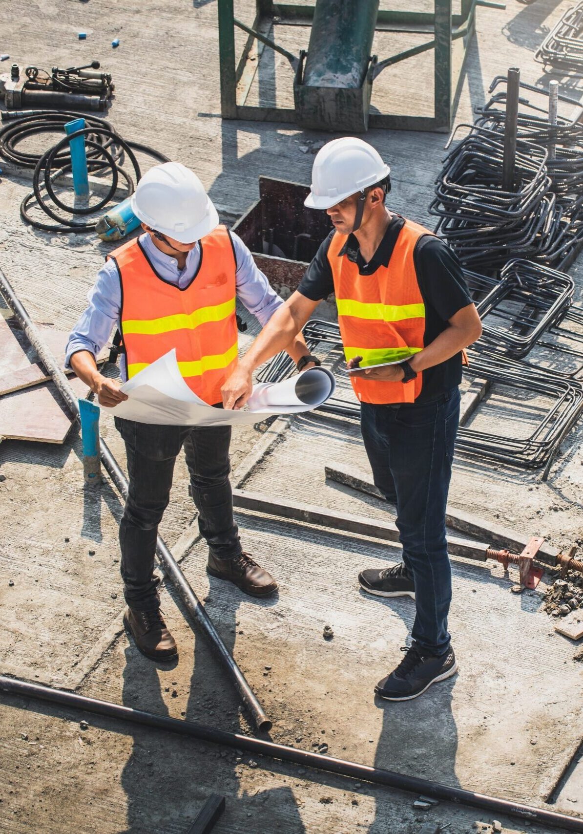 Two,Engineer,In,Hardhat,And,Orange,Jacket,Posing,On,Building
